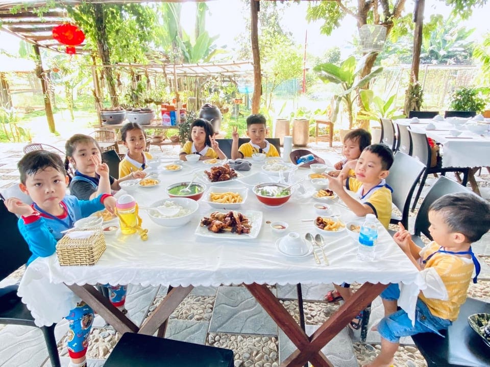 Children sitting together around a table sharing a meal