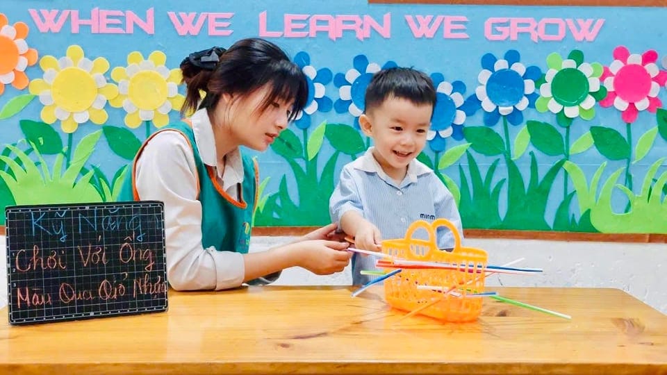 A teacher working one-to-one with a child at the learning board